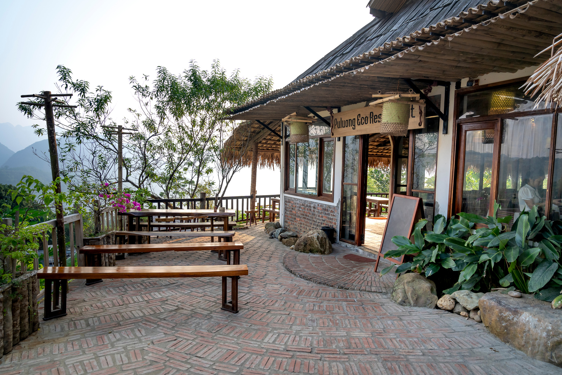 Cafe with outdoor tables in tropical resort